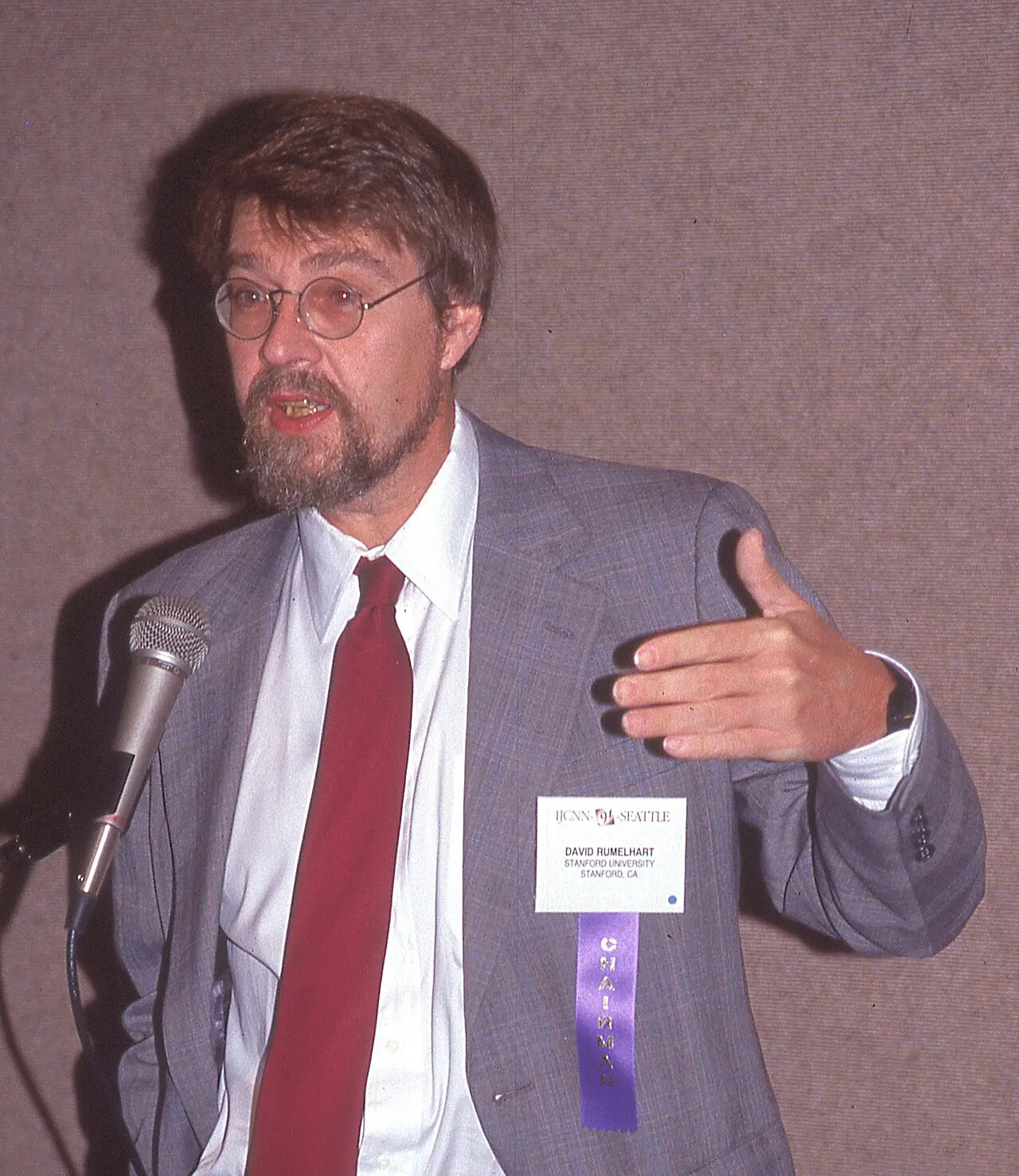David Rumelhart speaking at a microphone at the International Joint Conference on Neural Networks in Seattle, July 1991