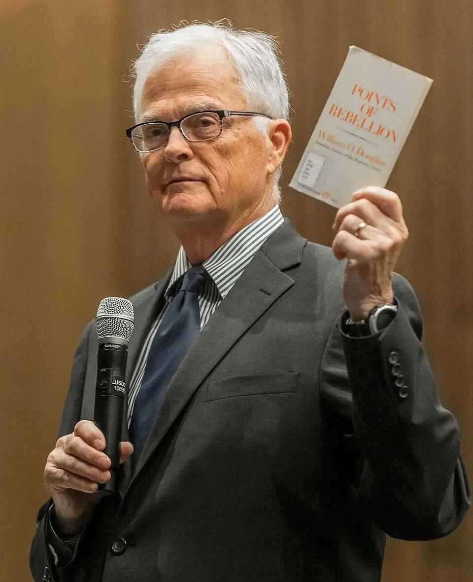 Judge William Alsup holding a book, in the official portrait published by the Northern District of California