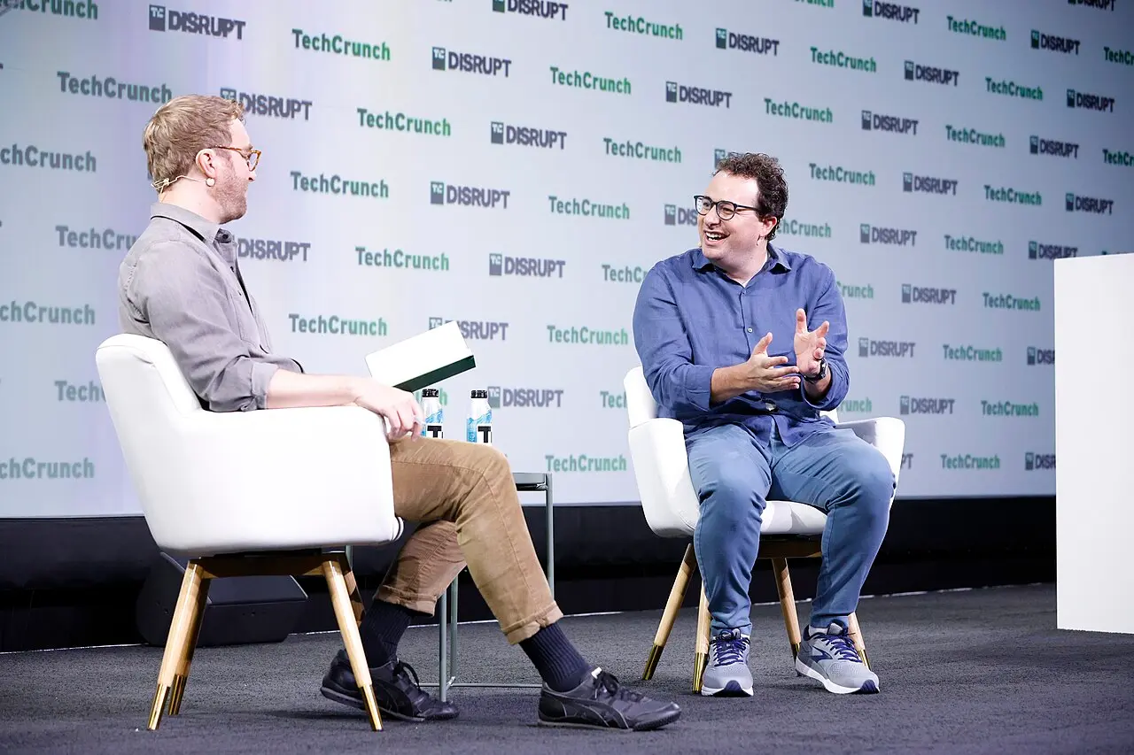 Anthropic's Dario Amodei (right) speaking with an interviewer on stage at TechCrunch Disrupt 2023