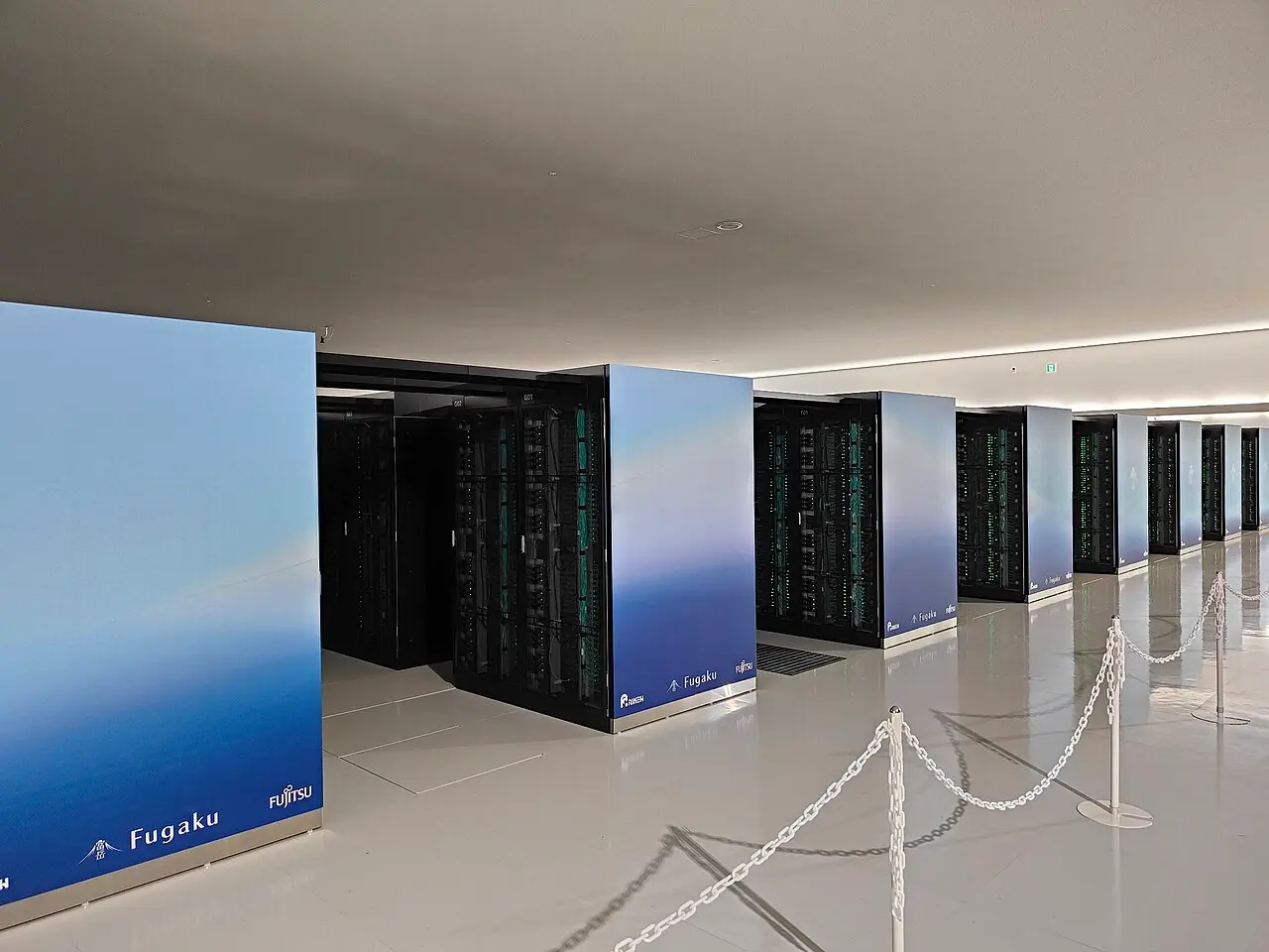 Rows of Fugaku racks at the RIKEN Center for Computational Science, with Fugaku, RIKEN and Fujitsu logos on the side panels