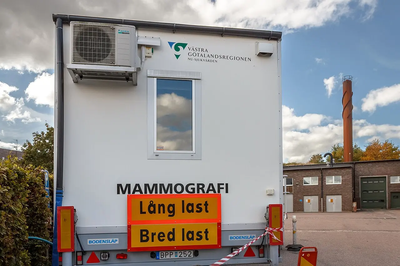 Rear of a mobile mammography trailer at Lysekil hospital in western Sweden, marked 'MAMMOGRAFI' with the regional health authority's logo (photographed 2022; not a MASAI trial site)