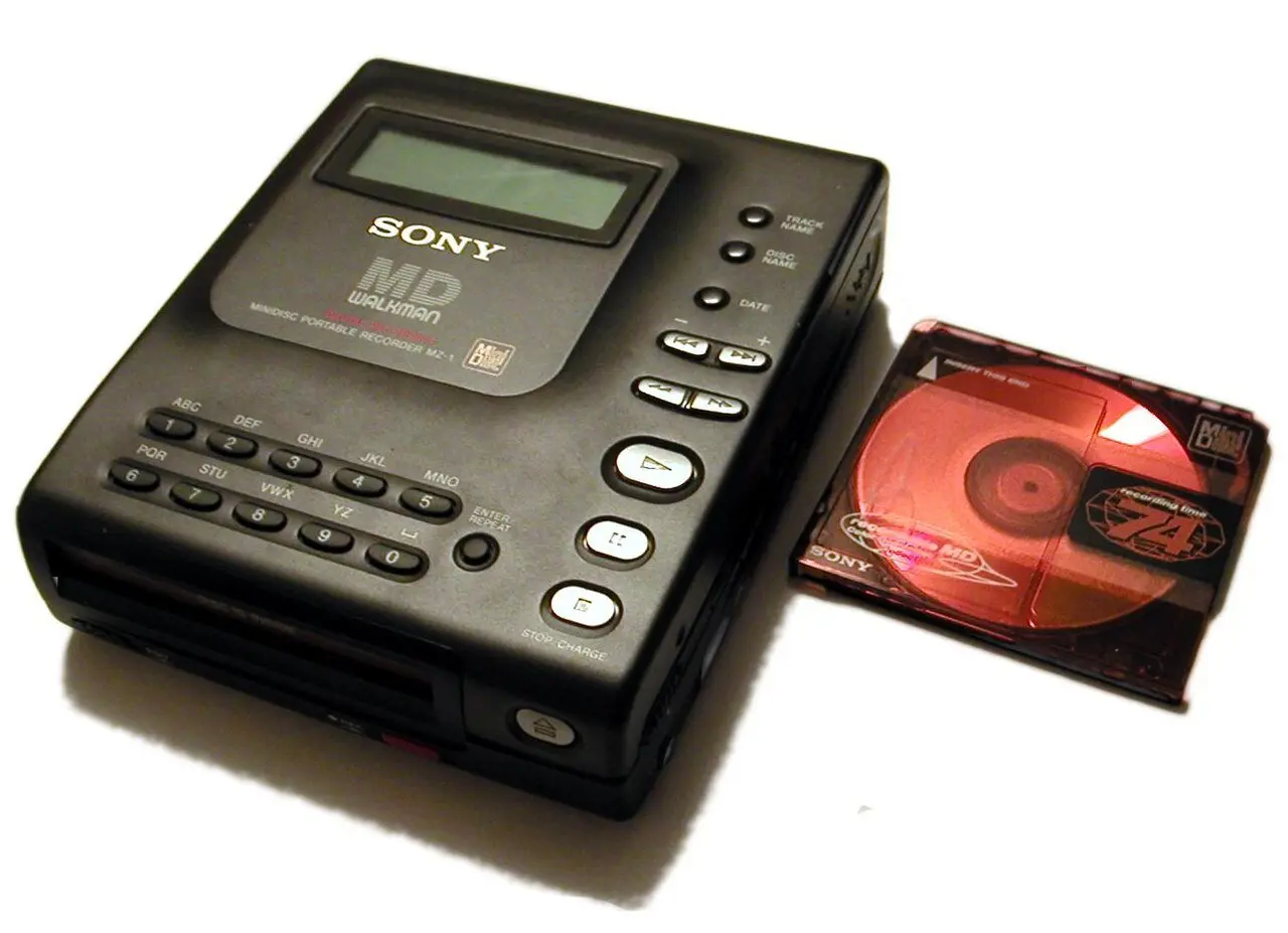 Sony's first MiniDisc recorder, the MZ-1, beside a MiniDisc in its cartridge