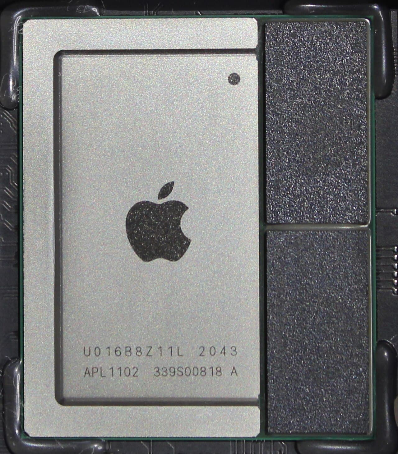 Close-up of an Apple M1 chip (marked APL1102) on the logic board of a 2020 Mac mini, with the two memory dies sharing the package